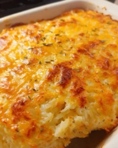 Delicious hashbrown casserole served in a baking dish with cheesy topping.