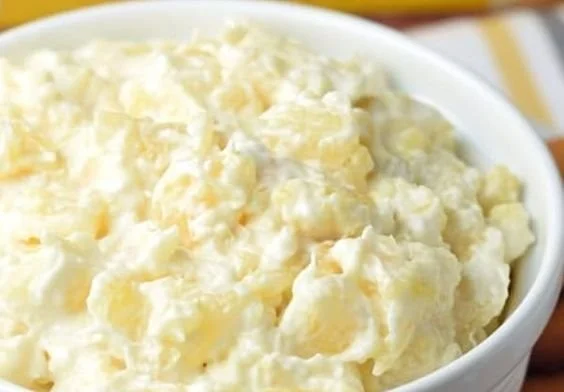 Delicious Cheesecake Pineapple Dip served in a bowl with pineapple chunks